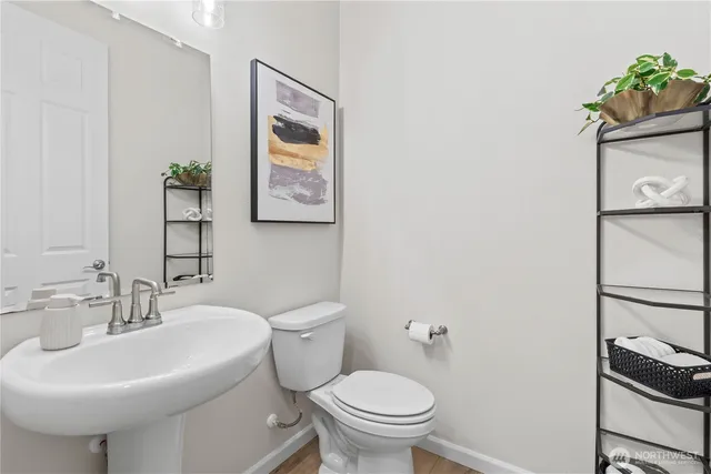 a bathroom with a sink toilet and mirror