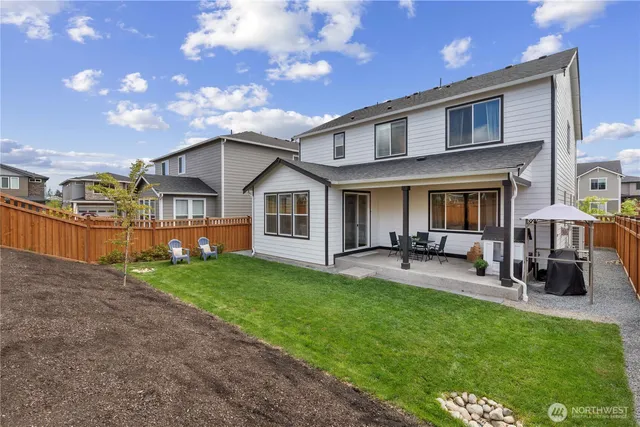 a front view of a house with patio and garden