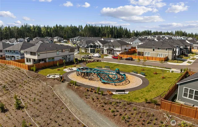 a swimming pool with outdoor seating and kitchen