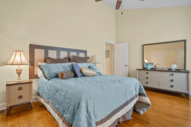 a bedroom with a bed and a large window