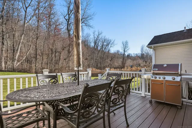 a view of a dinning table and chairs on the roof deck