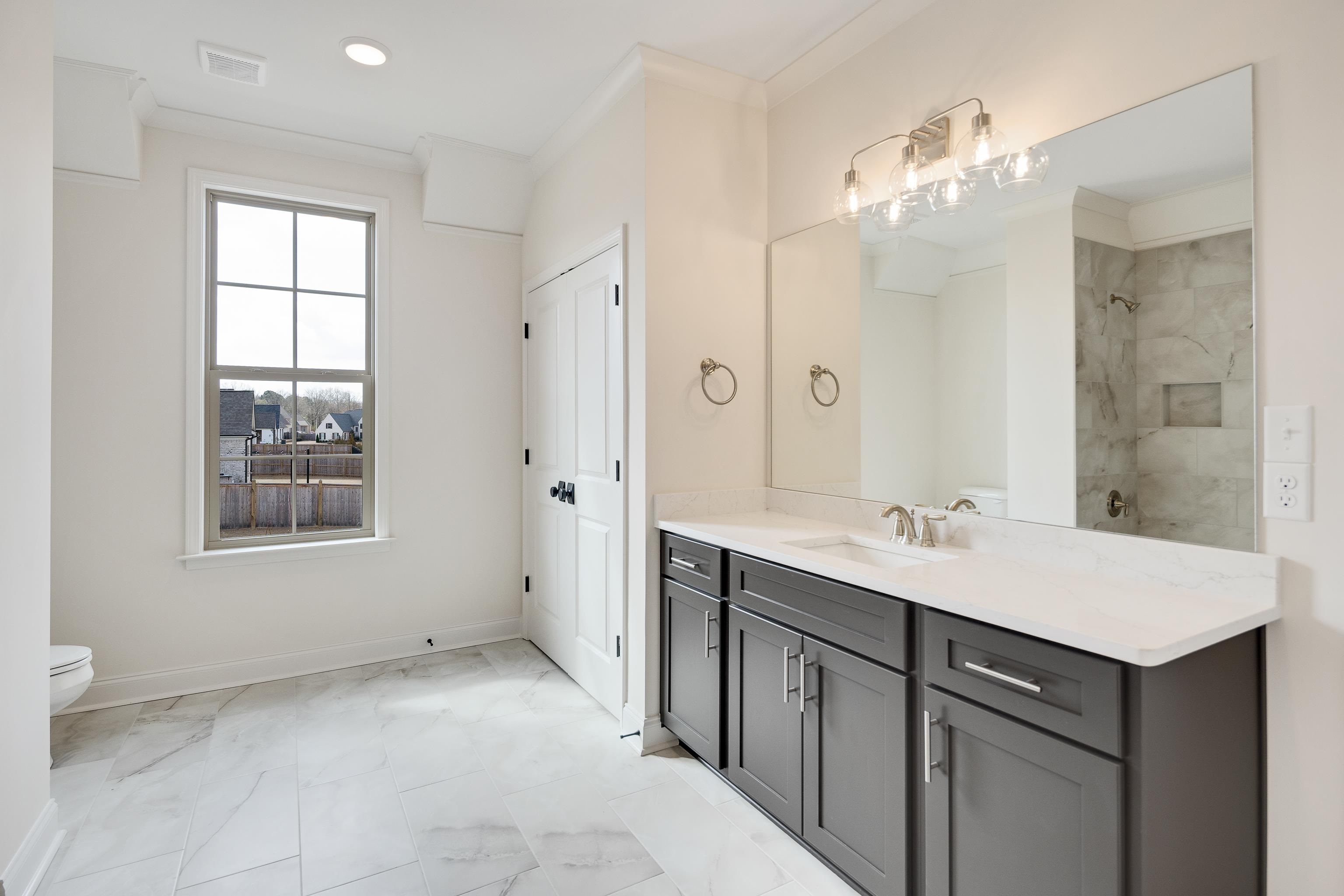 284 Keisie Lane Collierville, TN 38017 - Photo 23 of 34 Dual vanity with dark wood-finish cabinetry and white countertops
