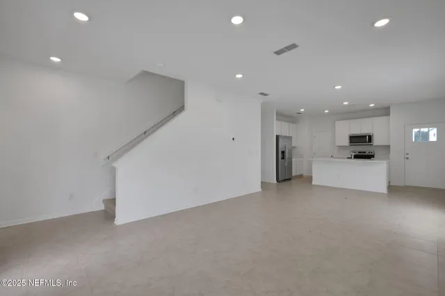 a view of a kitchen with a sink and a stove top oven