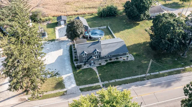 an aerial view of a house with garden space and street view