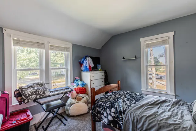 a bed room with a bed and a chair