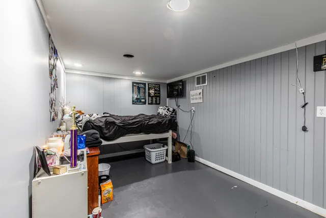 a bathroom with a toilet mirror and a sink