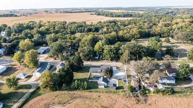 a view of an house with backyard and tree