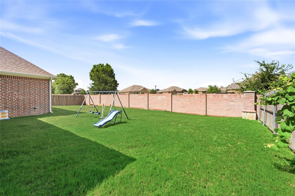 140 Chestnut Road Waxahachie, TX 75165 - Photo 23 of 26 Expansive backyard featuring a lush lawn, a full brick perimeter wall, and a wood fence accent
