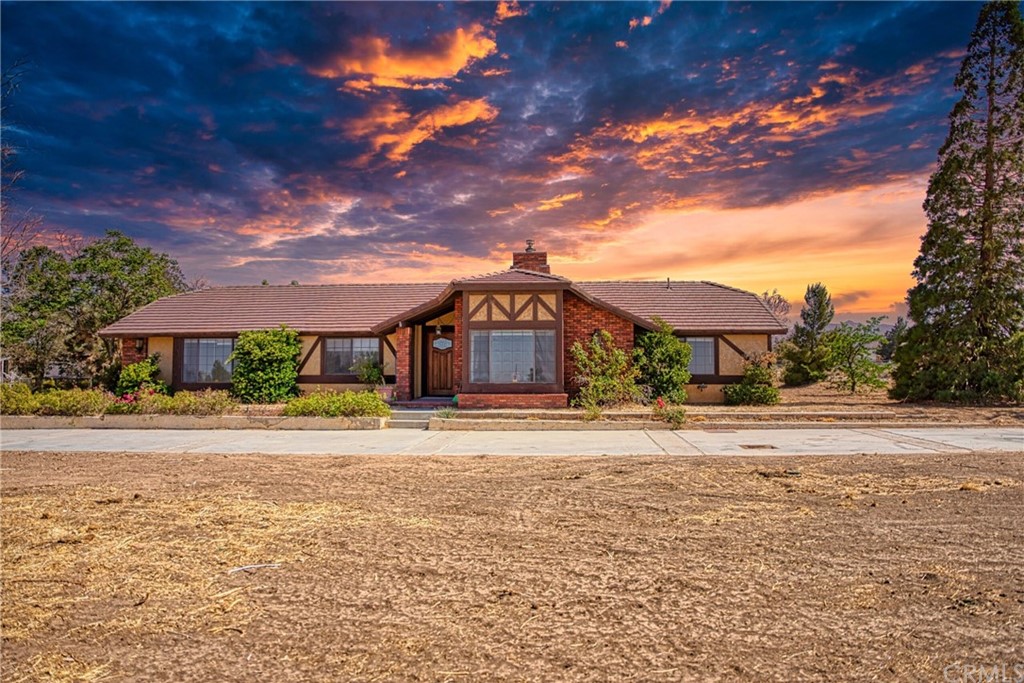 6727 Cambria Road Phelan, CA 92371 - Photo 1 of 1 a front view of a house with a garden
