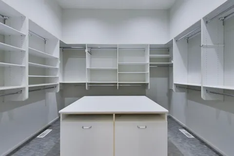a view of a room with wooden floor and windows