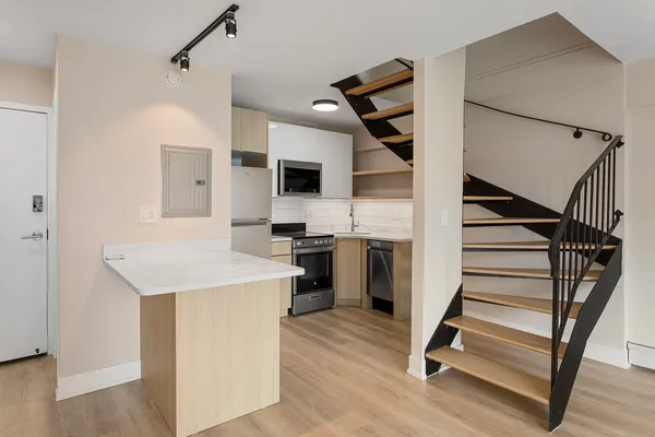 a view of kitchen with sink microwave and refrigerator