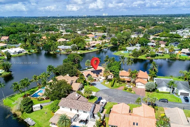an aerial view of residential house with outdoor space and lake view
