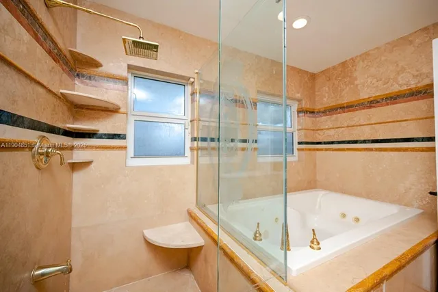 a bathroom with a tub and a shower