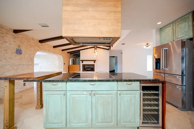 a kitchen with a refrigerator and cabinets