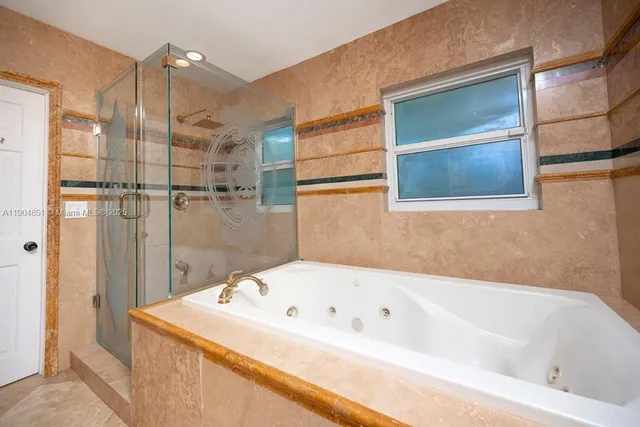 a bathroom with a bathtub and shower