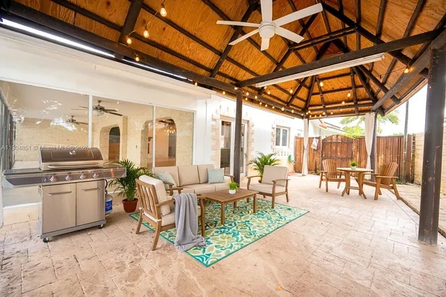 a view of a patio with a table and chairs