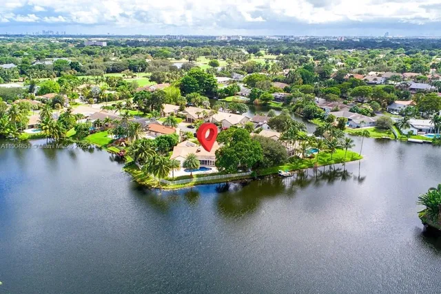 an aerial view of a houses with a lake view