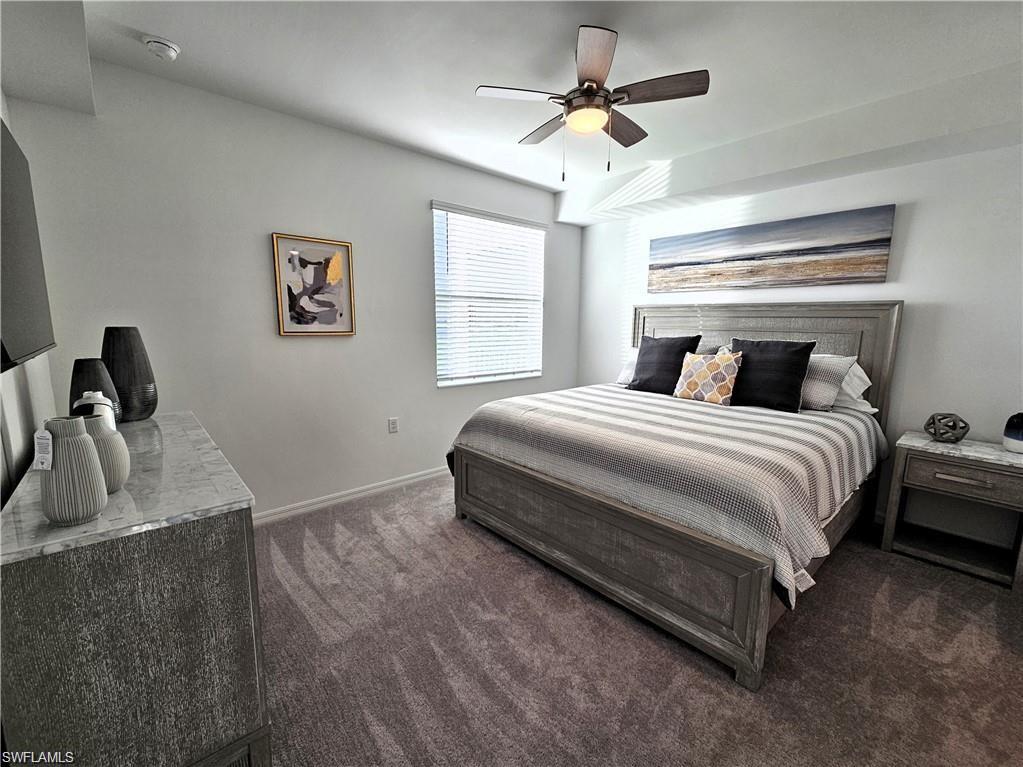5807 Double Eagle Cir Avenue, Unit 4621 Immokalee, FL 34142 - Photo 11 of 46 Bedroom featuring baseboards, ceiling fan, and dark carpet