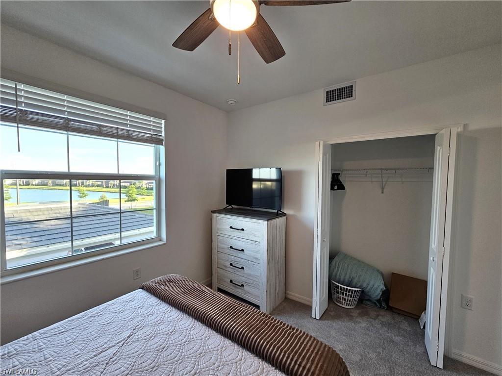 5807 Double Eagle Cir Avenue, Unit 4621 Immokalee, FL 34142 - Photo 22 of 46 Bedroom featuring a closet, a ceiling fan, baseboards, visible vents, and carpet
