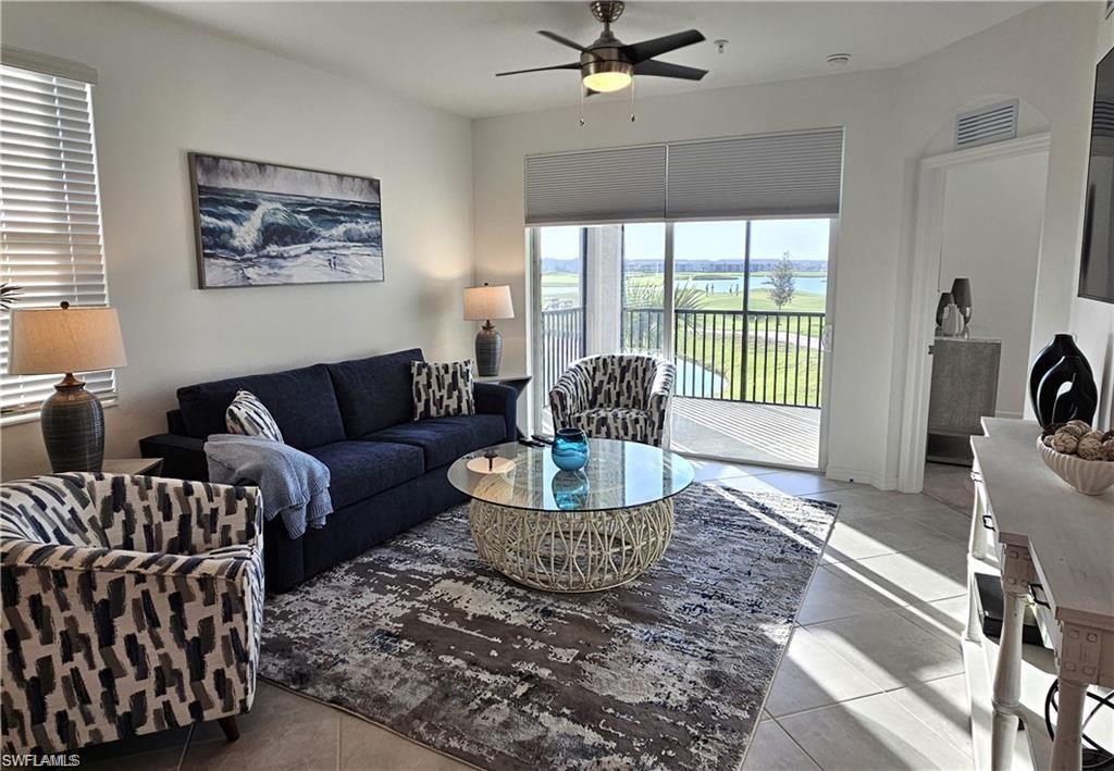 5807 Double Eagle Cir Avenue, Unit 4621 Immokalee, FL 34142 - Photo 4 of 46 Living area with light tile patterned floors, visible vents, and a ceiling fan
