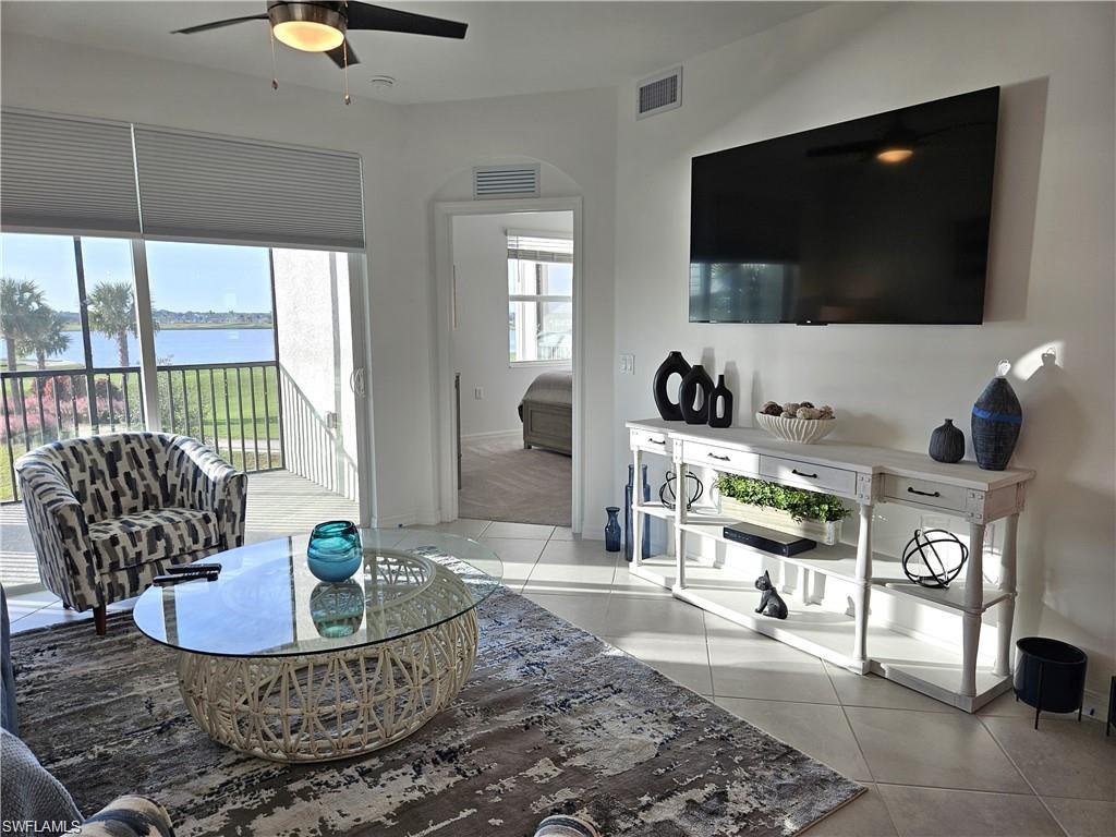 5807 Double Eagle Cir Avenue, Unit 4621 Immokalee, FL 34142 - Photo 5 of 46 Living room featuring light tile patterned floors, ceiling fan, and visible vents