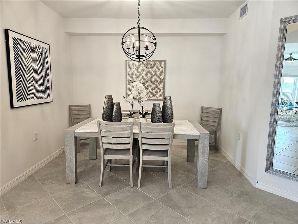 5807 Double Eagle Cir Avenue, Unit 4621 Immokalee, FL 34142 - Photo 8 of 46 Dining room with light tile patterned floors, a notable chandelier, baseboards, and visible vents