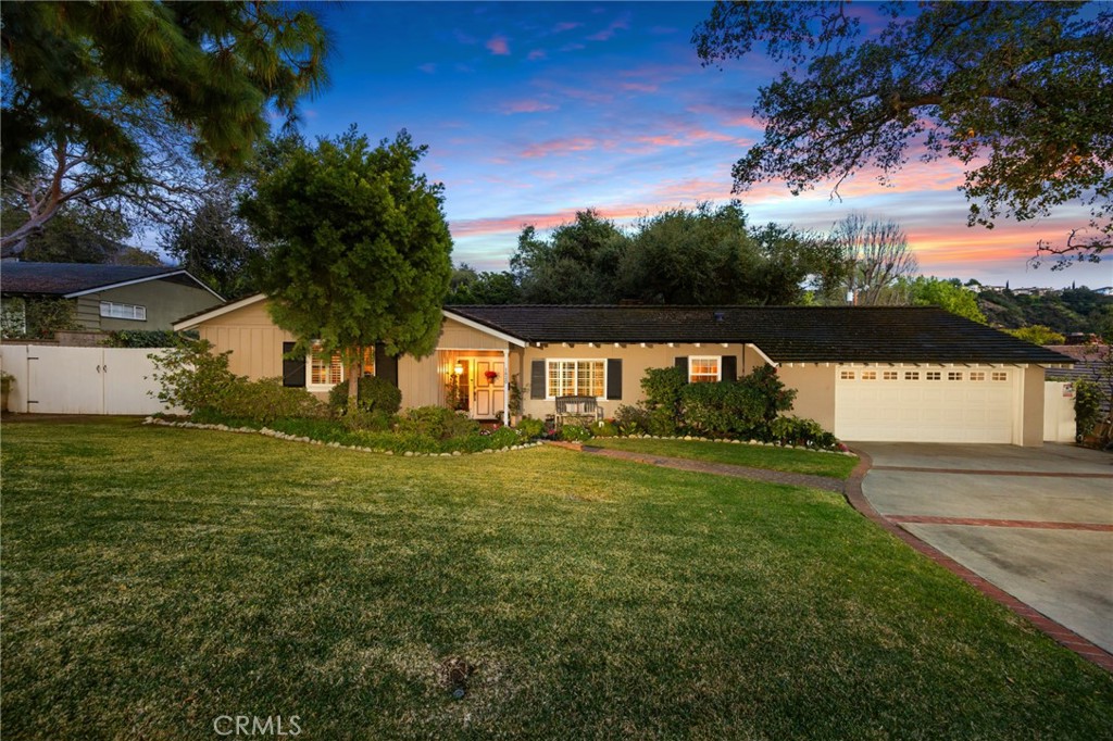 a front view of house with yard and green space