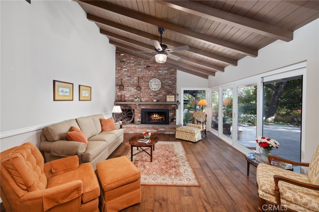 1820 Alta Oaks Drive Arcadia, CA 91006 - Photo 12 of 56 a living room with furniture a fireplace and a floor to ceiling window