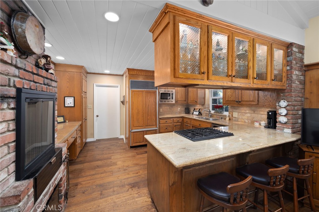 1820 Alta Oaks Drive Arcadia, CA 91006 - Photo 21 of 56 a kitchen that has a sink a table and chairs in it