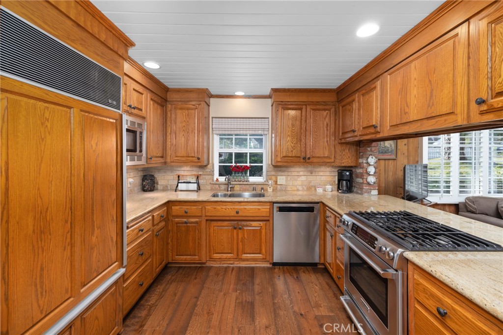 1820 Alta Oaks Drive Arcadia, CA 91006 - Photo 22 of 56 a kitchen with stainless steel appliances granite countertop a stove sink and cabinets