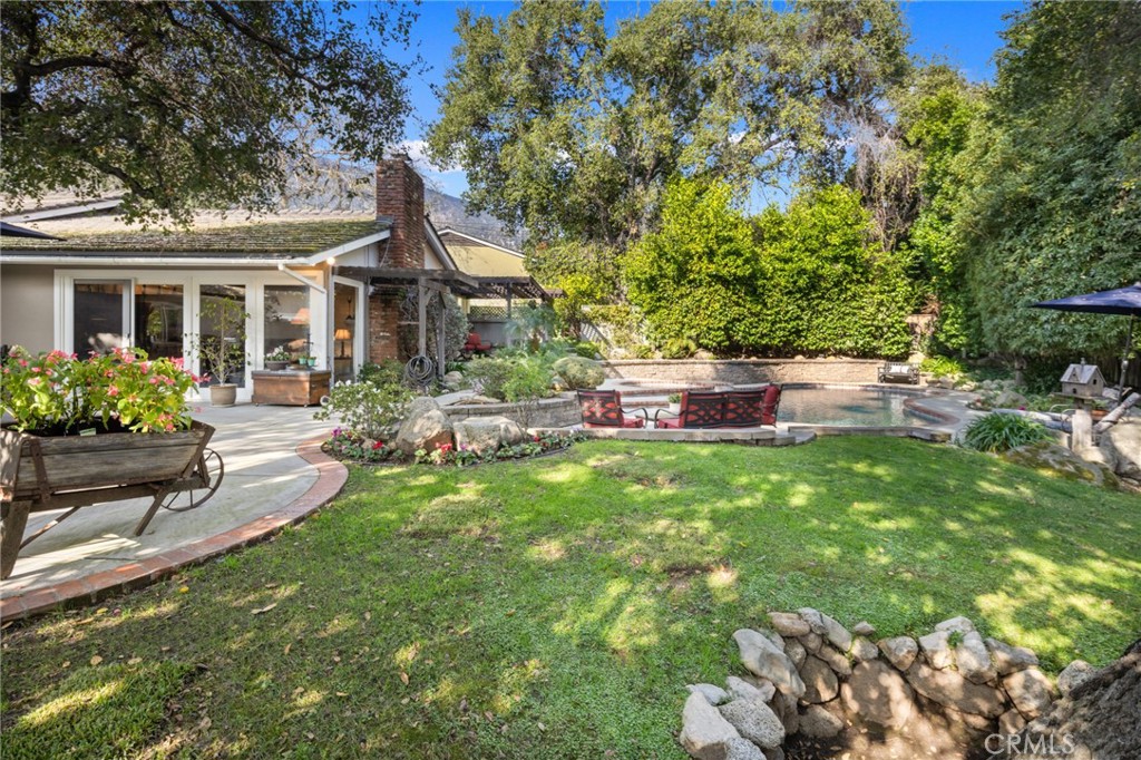 1820 Alta Oaks Drive Arcadia, CA 91006 - Photo 46 of 56 a front view of a house with a garden and trees