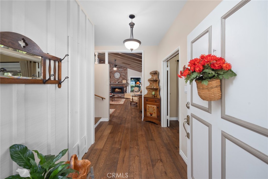 1820 Alta Oaks Drive Arcadia, CA 91006 - Photo 9 of 56 a view of a hallway with wooden floor and a kitchen