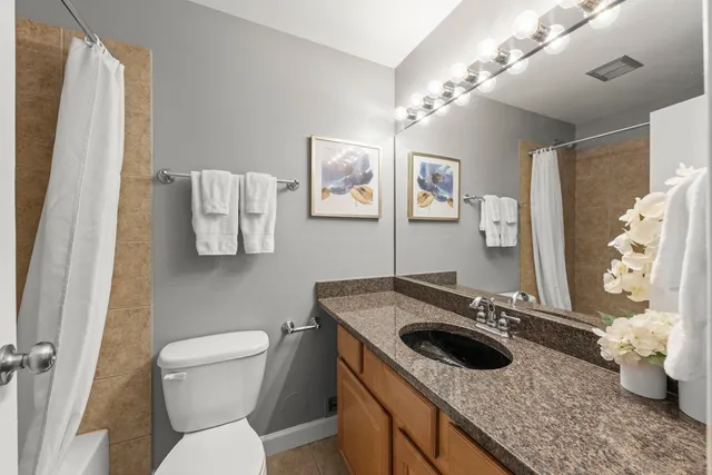 a bathroom with a sink toilet and mirror