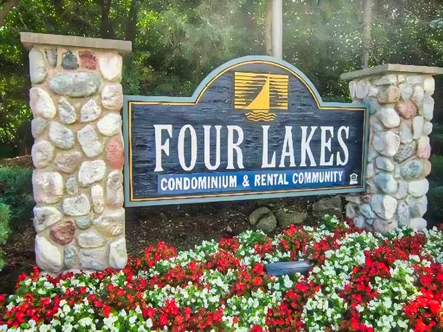 a view of sign board with flower garden