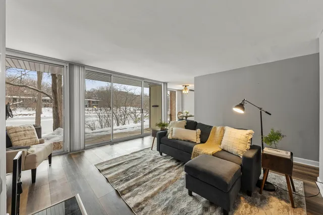 a bedroom with furniture and a large window