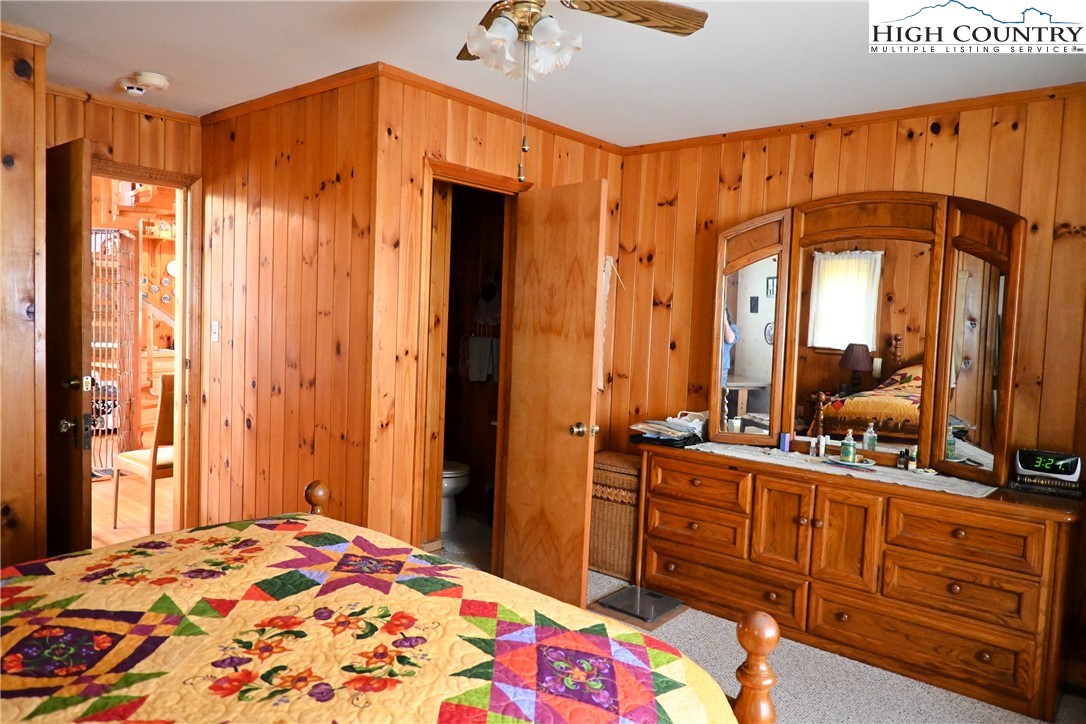 280 Smoky Hollow Road Laurel Springs, NC 28644 - Photo 17 of 42 a bedroom with a bed a dresser and mirror