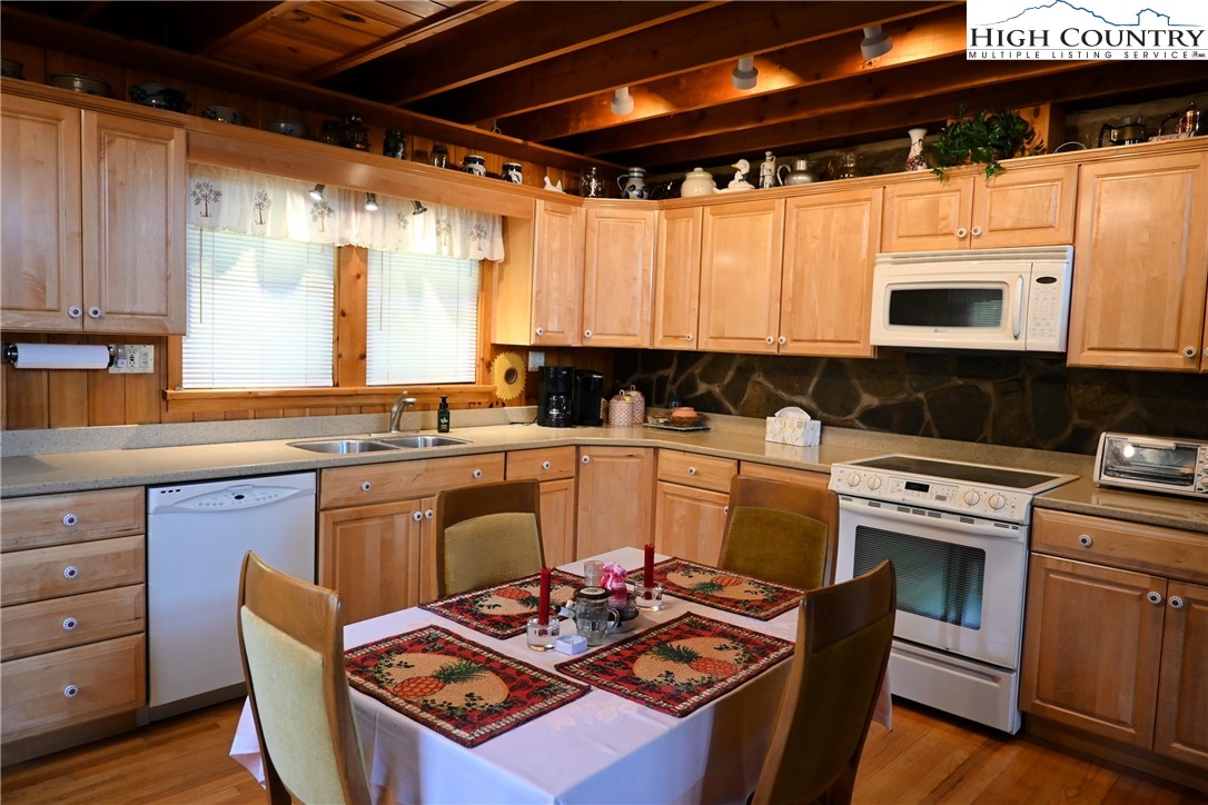 280 Smoky Hollow Road Laurel Springs, NC 28644 - Photo 5 of 42 a kitchen with stainless steel appliances granite countertop a stove a sink and a microwave
