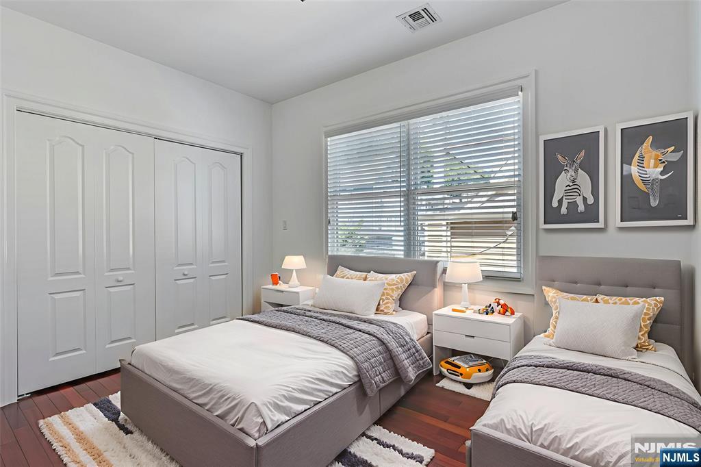 52 Myrtle Avenue, Unit B Edgewater, NJ 07020 - Photo 11 of 20 a bedroom with a bed and a window