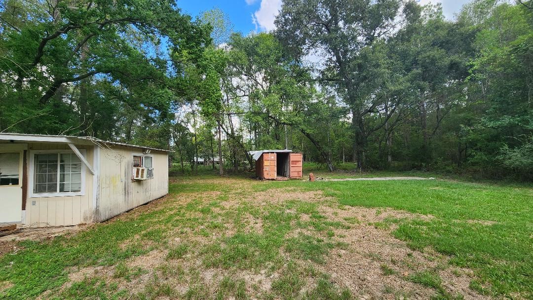 26835 Long Street Splendora, TX 77372 - Photo 13 of 16 a backyard of a house with trees and entertaining space