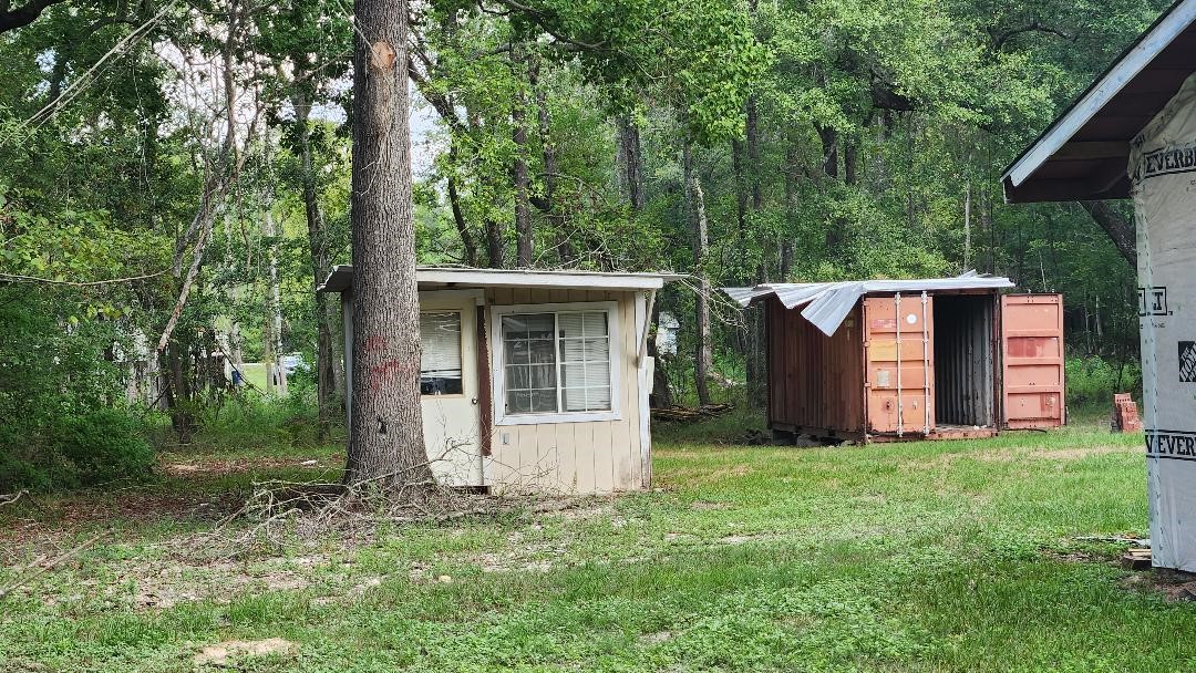 26835 Long Street Splendora, TX 77372 - Photo 15 of 16 a view of a house with backyard and garden