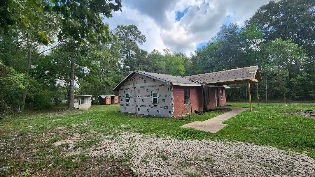 26835 Long Street Splendora, TX 77372 - Photo 16 of 16 a view of a house with yard and a garden