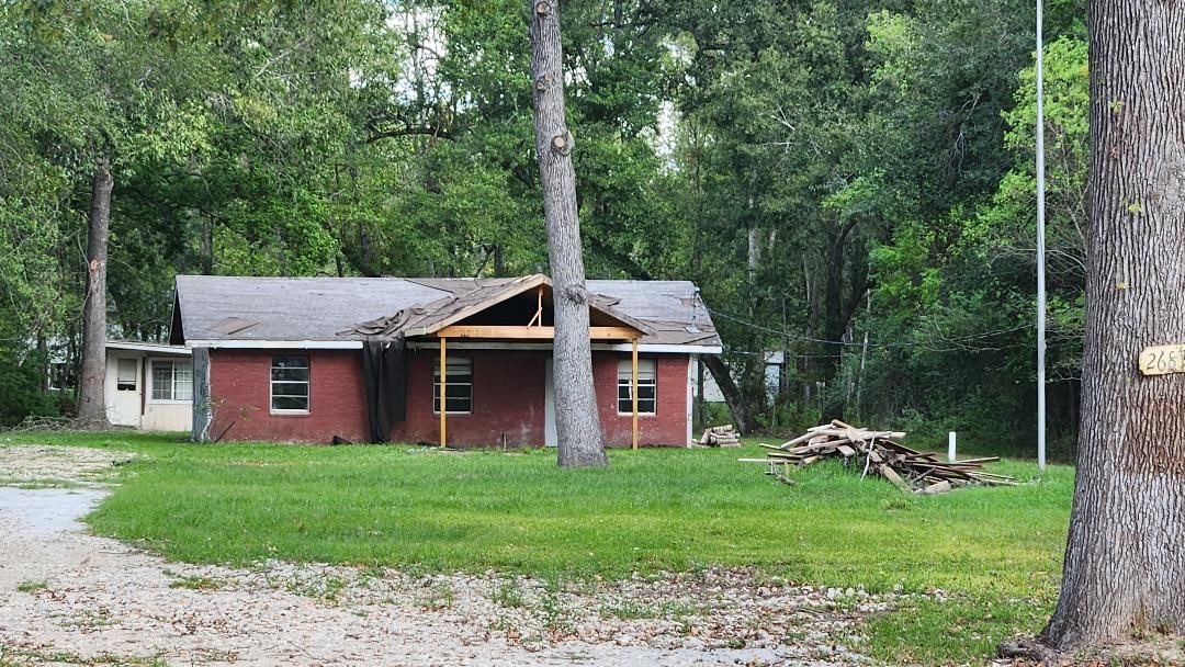 26835 Long Street Splendora, TX 77372 - Photo 5 of 16 a view of a house with a yard and sitting area