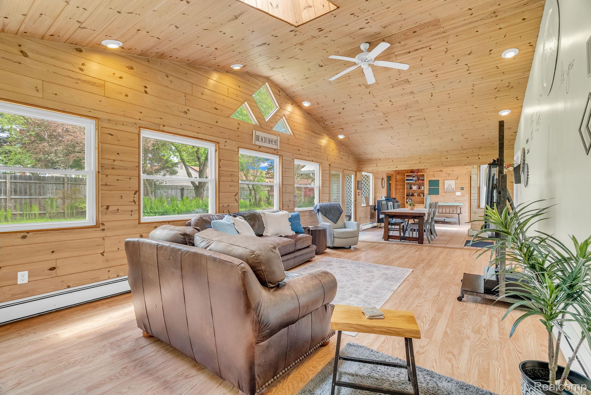 7489 Aspen Road Lexington, MI 48450 - Photo 17 of 62 Expansive living area featuring wood-finish flooring, paneled walls and vaulted ceilings with recessed lighting