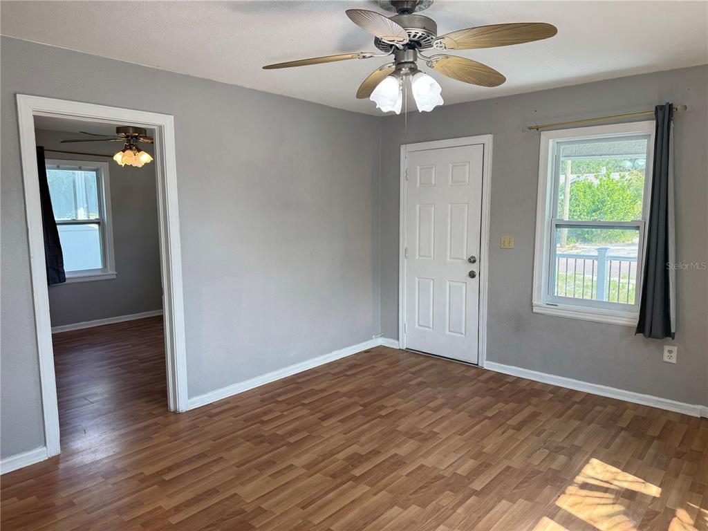 1009 Druid Road Clearwater, FL 33756 - Photo 3 of 9 wooden floor in an empty room with a window