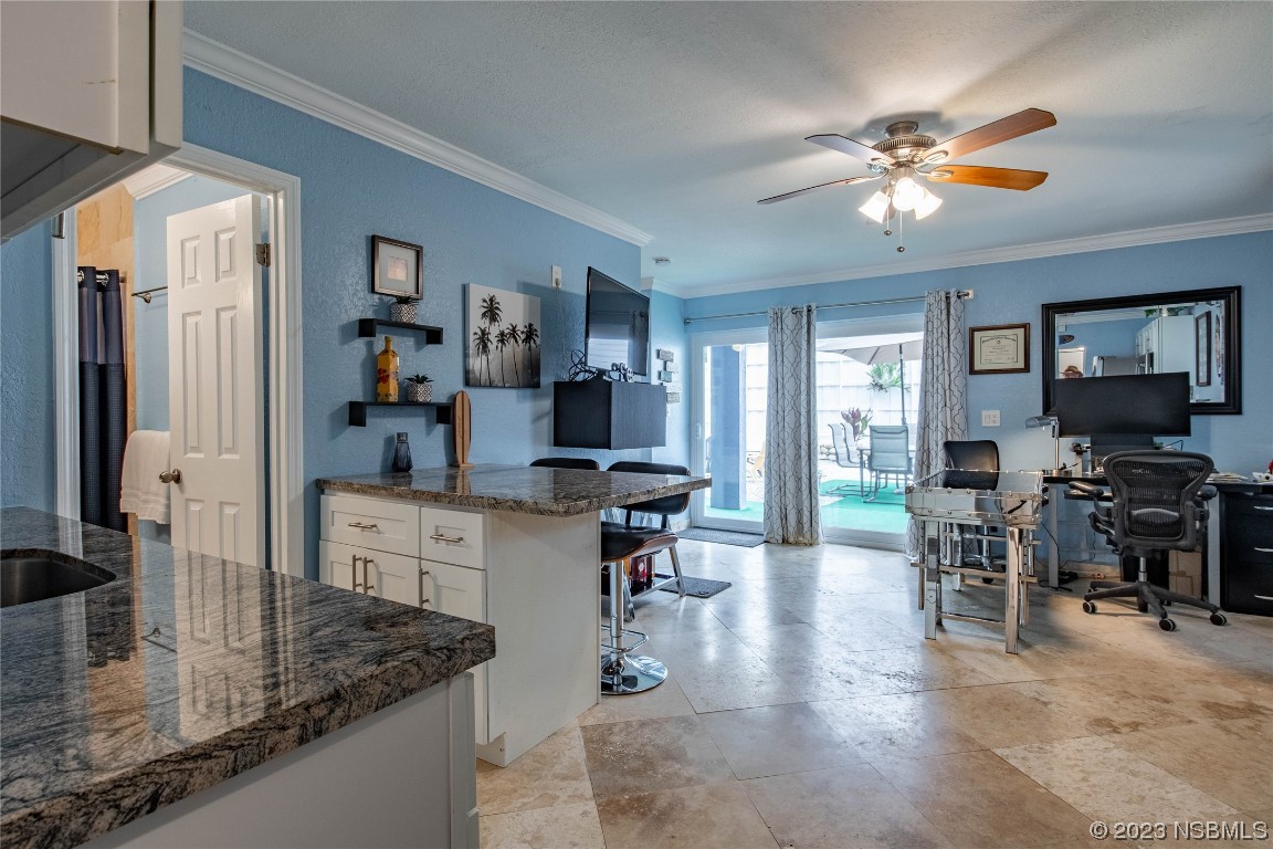 6531 Turtlemound Road New Smyrna Beach, FL 32169 - Photo 27 of 42 a kitchen with stainless steel appliances granite countertop sink cabinets and wooden floor