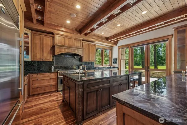 a kitchen with stainless steel appliances granite countertop a stove and cabinets