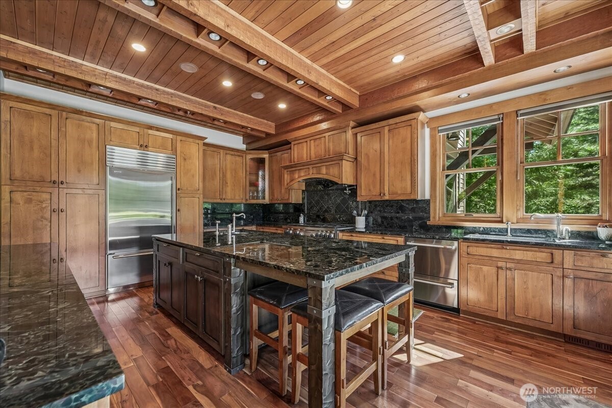 50 Larkspur Loop Cle Elum, WA 98922 - Photo 13 of 36 a kitchen with stainless steel appliances granite countertop a stove a sink and wooden cabinets