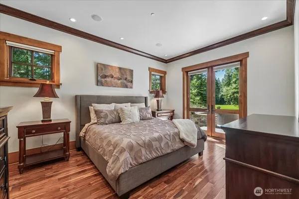 a bedroom with a large bed and a large window