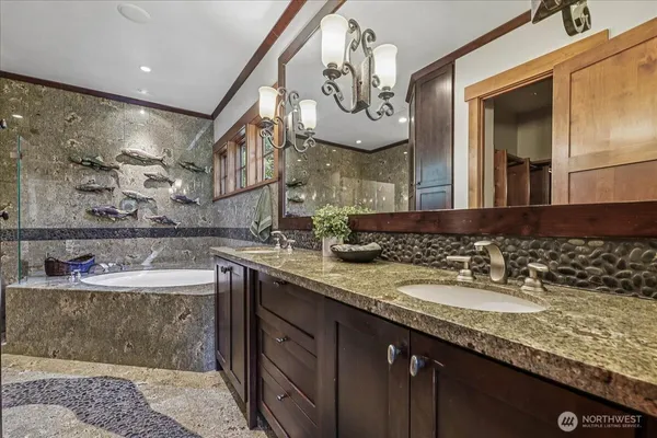 a bathroom with a granite countertop sink a large mirror and vanity