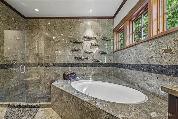 a bathroom with a granite countertop sink a mirror and shower